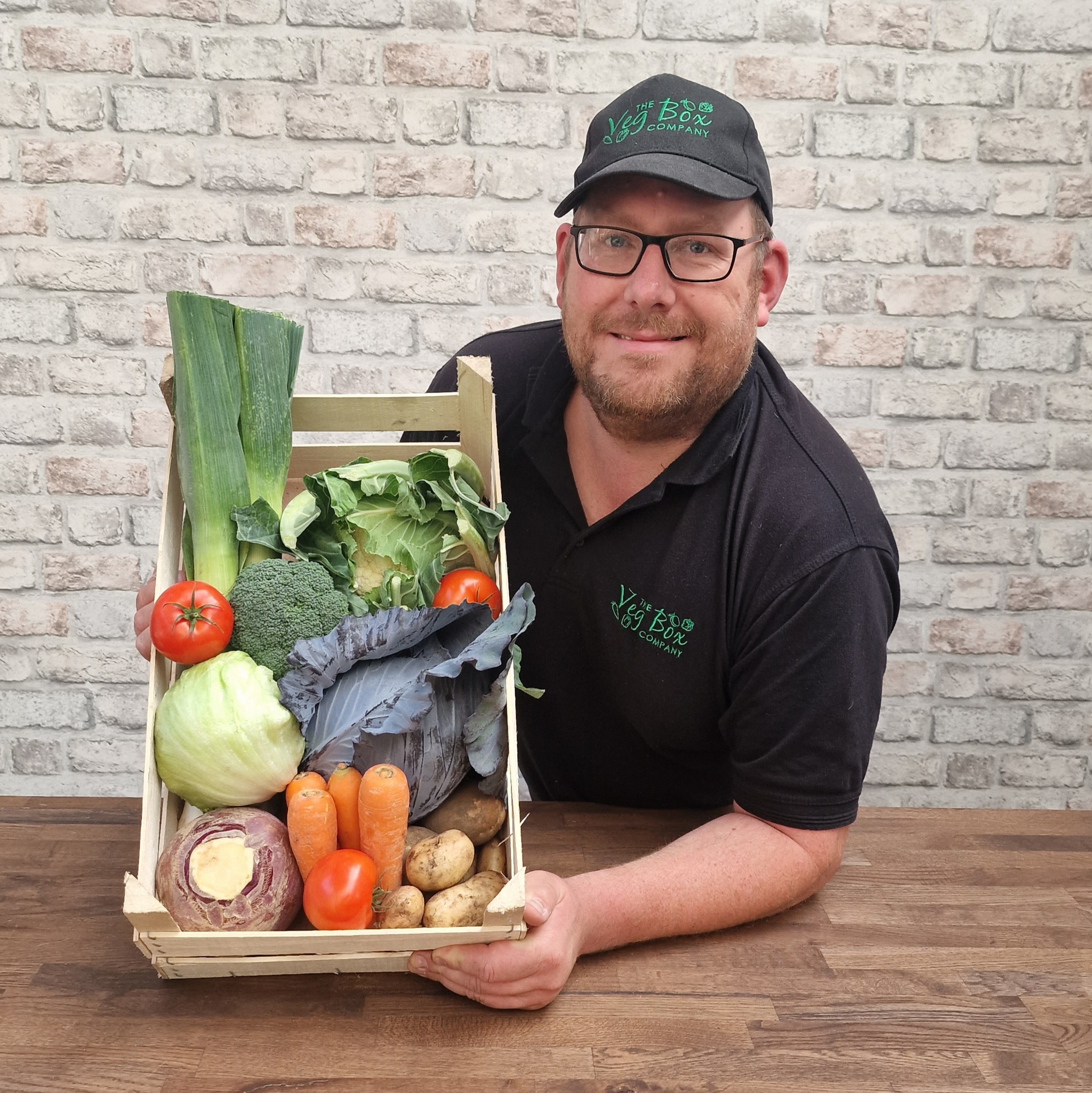 Guy The Farmer - Holding a box of farm fresh fruit and vegetables
